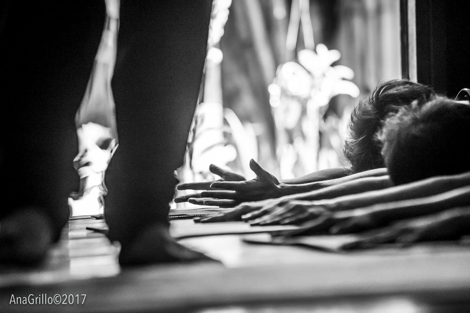 Wild Rose Yoga Studio Chiang Mai Thailand Lunar Yoga Flow Class with teacher next to yoga students in childs postures with hands extended forward with studio door open to the yoga studio garden in the background.