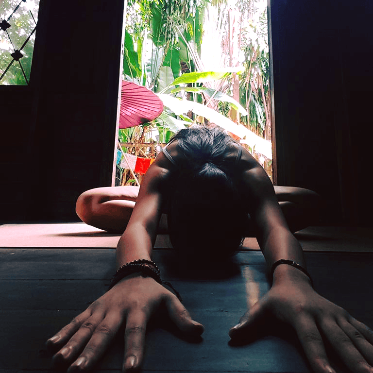 Yoga Student at Wild Rose Yoga Chiang Mai in a cooling yin yoga forward fold