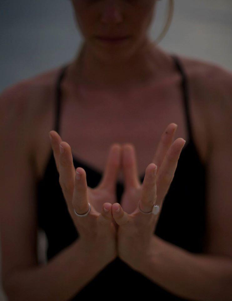 hands in lotus mudra as an offering of intention for a purposeful yoga practice.